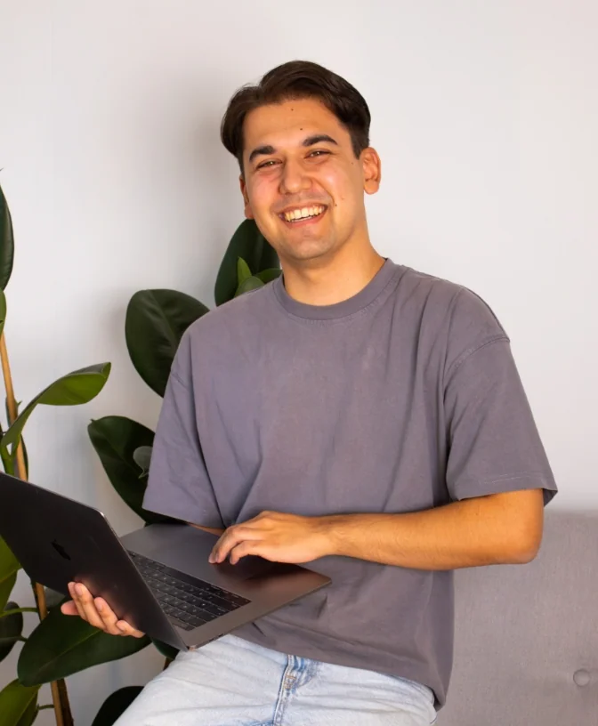 Sebastiaan die aan het lachen is achter zijn computer